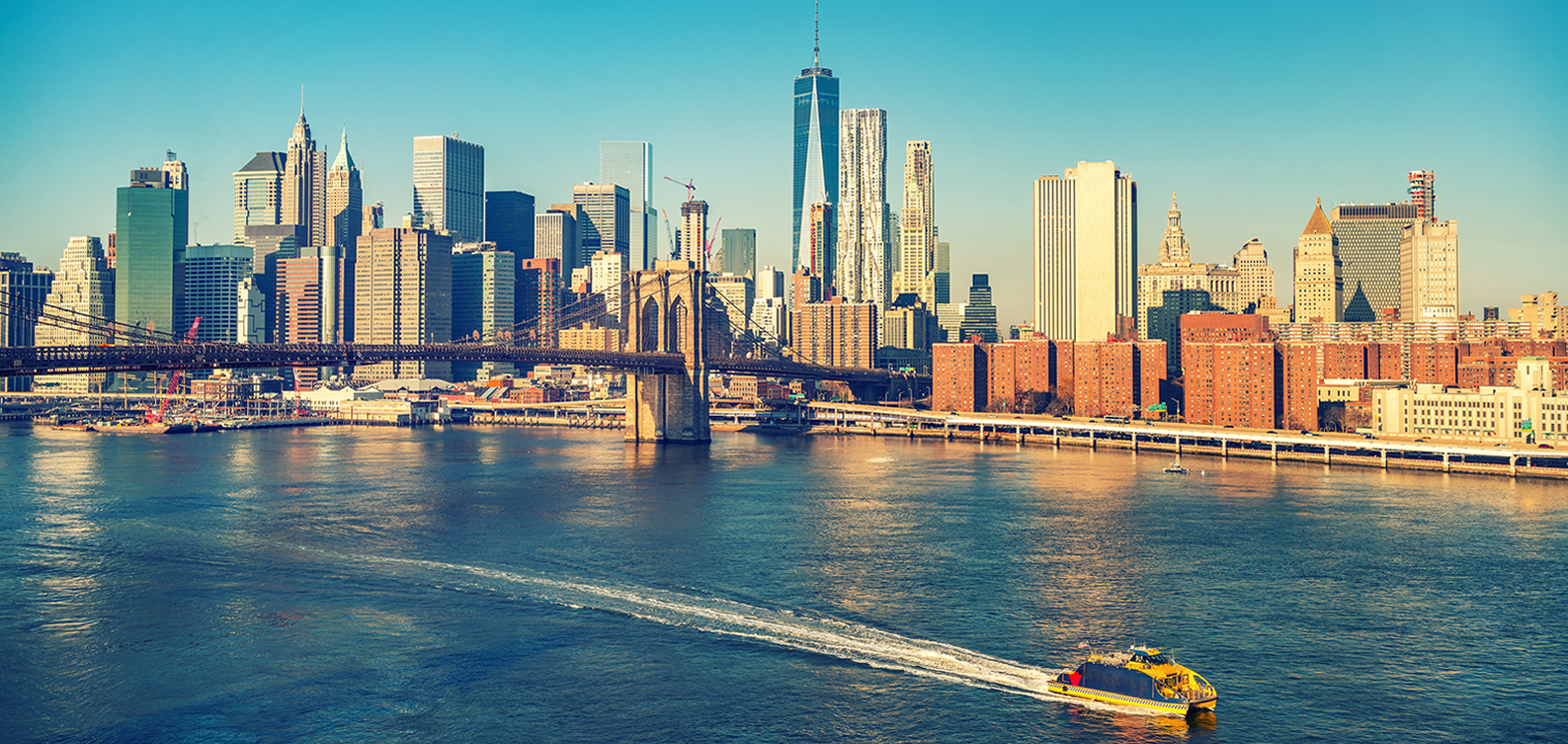 Skyview of the Brooklyn Bridge and Freedom Tower with Rental Boat in the East River