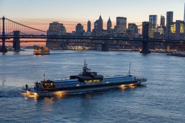 Bateux Yacht Sailing Across the East River the New York City Skyline Backdrop 
